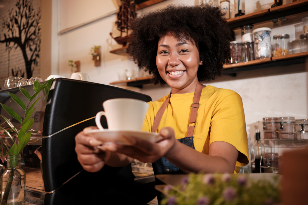 Barista serving coffee at a Small Coffee Shop Business